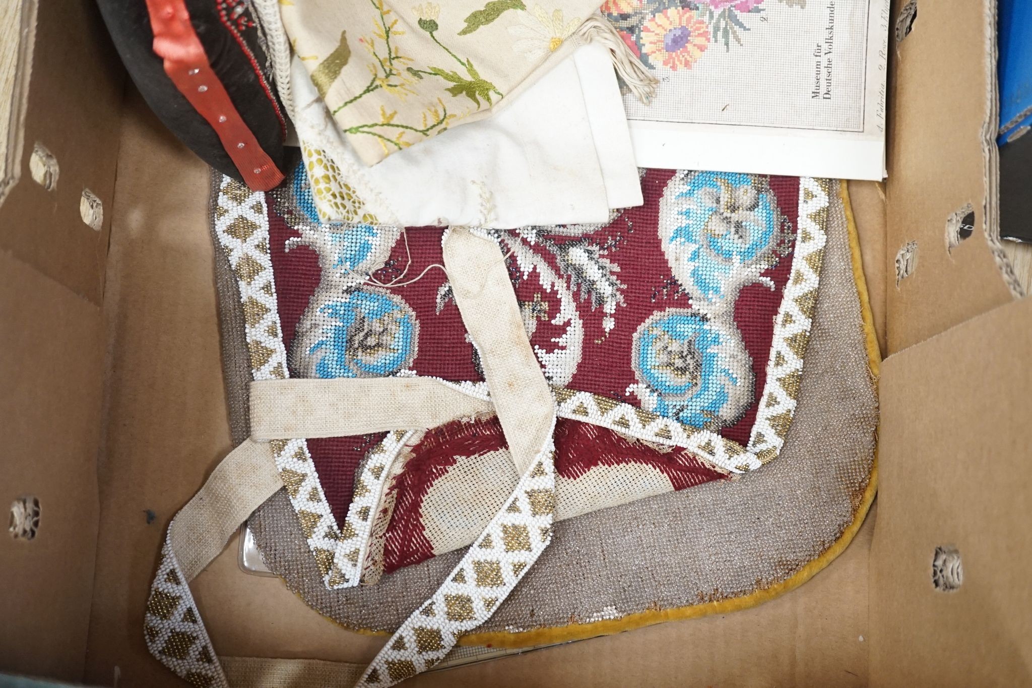 A Berlin beadwork panel , another, a beaded cushion, a book and embroidered banners, 2 silk panels etc
